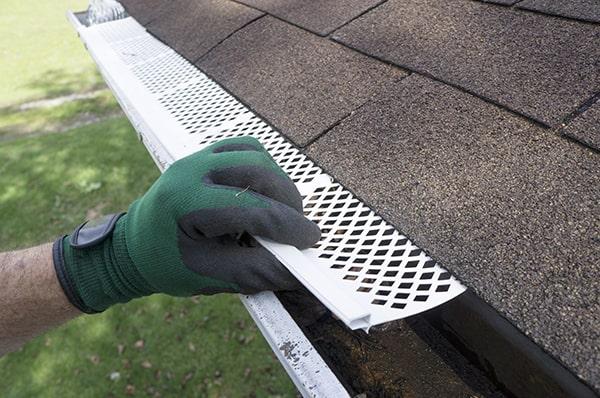gutter guards act as a barrier, allowing water to flow freely while keeping leaves, twigs, and other debris out