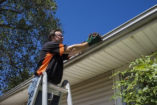a close-up of a gutter being repaired with tools in Watertown, CT